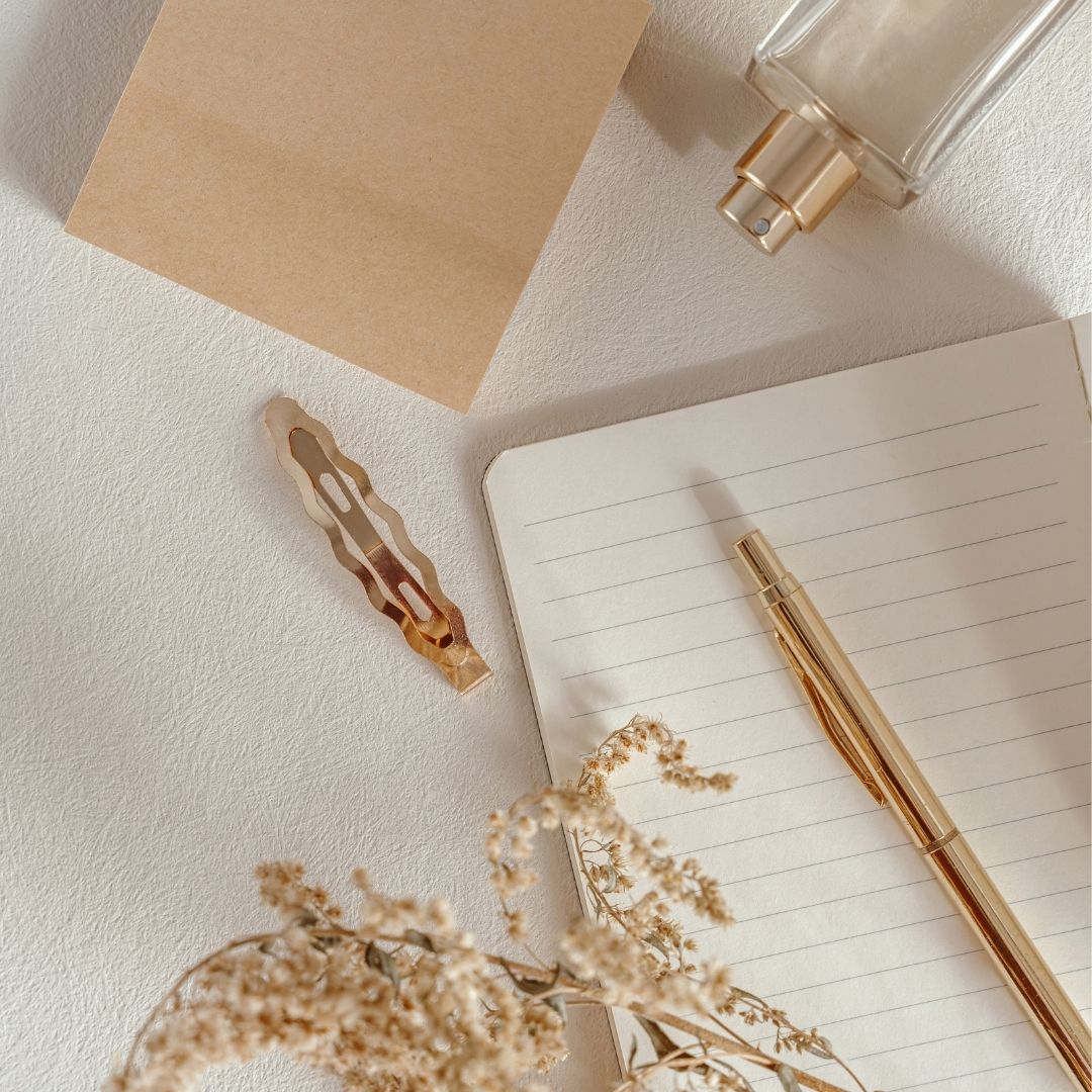 blank journal with gold pen flatlay