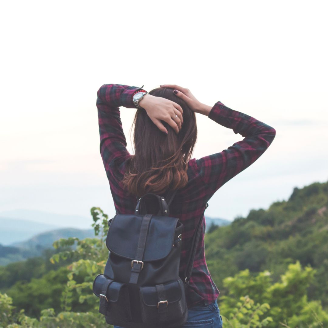 Back of woman looking at mountain on hike