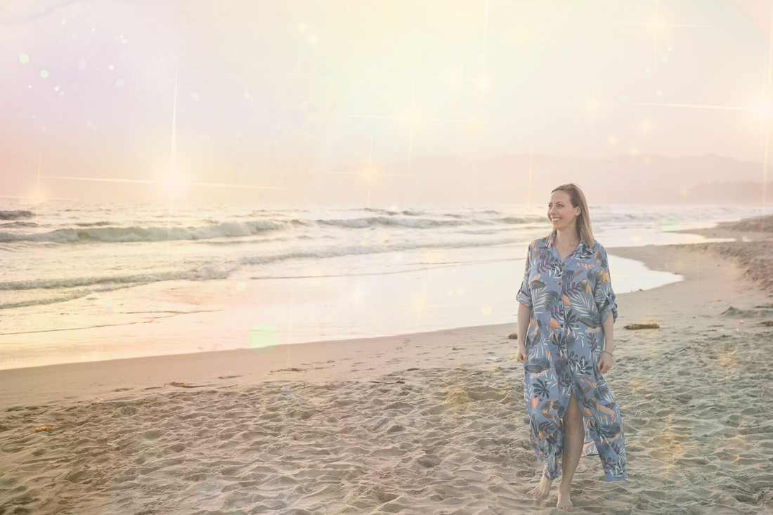 Woman walking on beach one-on-one manifestation coaching session from the Make Your Magic package
